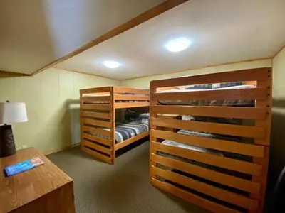 two bunk beds in a room with a desk at Grande Butte Lodge - by The Chalets in Laurelville