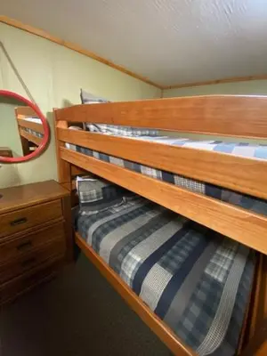 a bunk bed in a room with a wooden bed at Grande Butte Lodge - by The Chalets in Laurelville