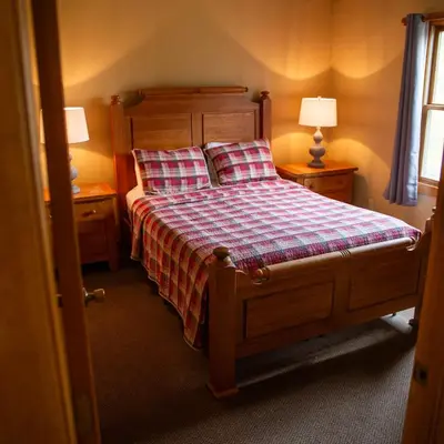 a bedroom with a bed with two lamps on two tables at Hawks Peak - by The Chalets in Logan