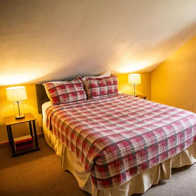 a bedroom with a large bed with two lamps at Hawks Peak - by The Chalets in Logan