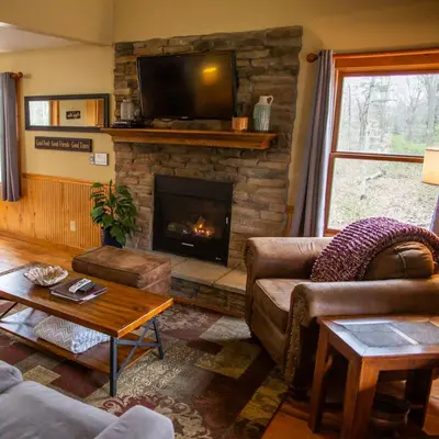 a living room with a couch and a fireplace at Hawks Peak - by The Chalets in Logan