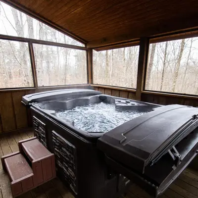 a large hot tub in a room with windows at Hawks Peak - by The Chalets in Logan