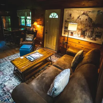 a living room with a couch and a coffee table at Hemlock - by The Chalets in Logan
