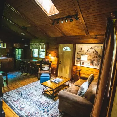 a living room with a couch and a table at Hemlock - by The Chalets in Logan
