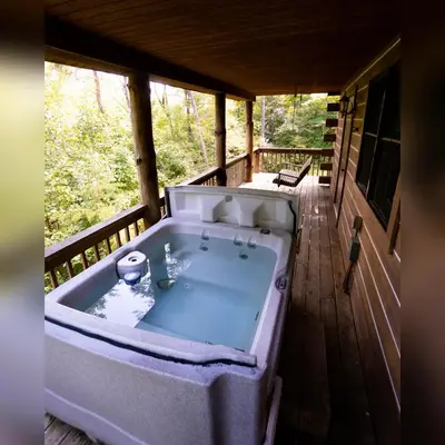 a large bath tub sitting on a porch at Hemlock - by The Chalets in Logan