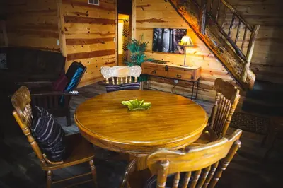 a wooden table and chairs in a cabin at Hidden Heights - by The Chalets in South Bloomingville
