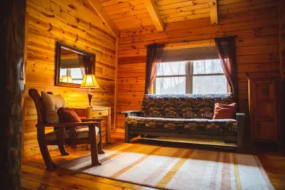 a room with a bench and a window in a log cabin at Hidden Heights - by The Chalets in South Bloomingville