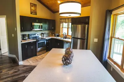 a kitchen with a table with a pineapple on it at Lakeview - by The Chalets in Logan