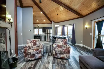 a living room with two chairs and a table at Lakeview - by The Chalets in Logan