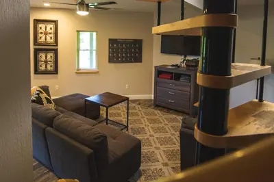 a living room with a couch and a television at Lakeview - by The Chalets in Logan