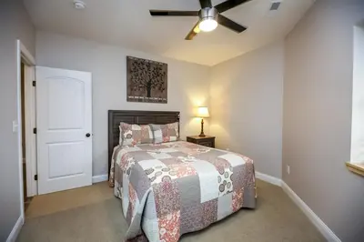 a bedroom with a bed and a ceiling fan at Lakeview - by The Chalets in Logan