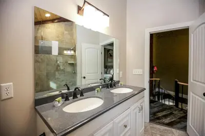 a bathroom with two sinks and a large mirror at Lakeview - by The Chalets in Logan