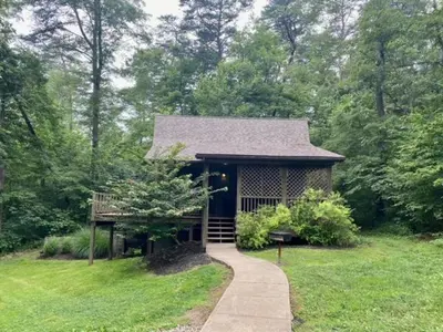 a small house in the middle of a field at Laurelwood - by The Chalets in Logan