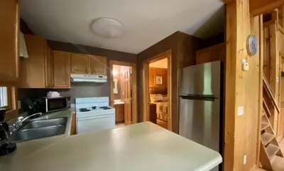 a kitchen with a sink and a refrigerator at Laurelwood - by The Chalets in Logan