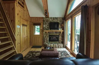 a living room with a couch and a fireplace at Laurelwood - by The Chalets in Logan