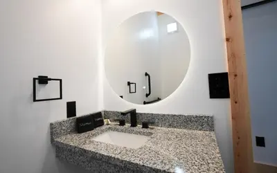a bathroom with a sink and a mirror at Legends Lane A - by The Chalets in Logan