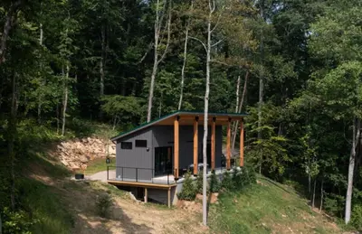a small house on a hill in the woods at Legends Lane A - by The Chalets in Logan