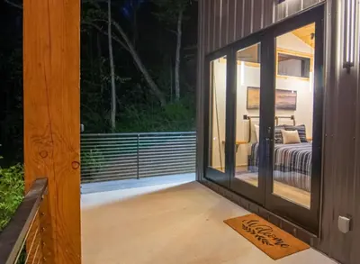 a room with a glass door leading to a bedroom at Legends Lane A - by The Chalets in Logan