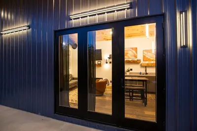a room with sliding glass doors and a dining room at Legends Lane D - by The Chalets in Logan