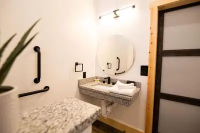 a bathroom with a sink and a mirror at Legends Lane D - by The Chalets in Logan