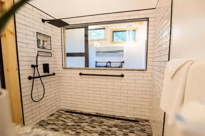 a bathroom with a shower with a mirror at Legends Lane E - by The Chalets in Logan