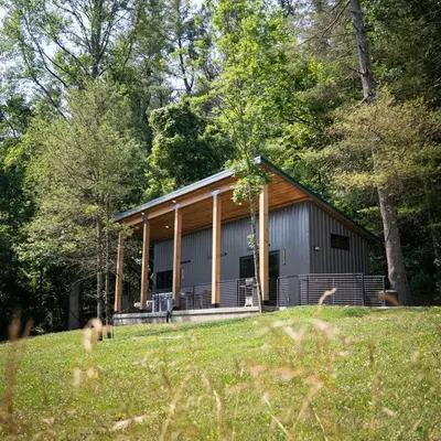 a building in the middle of a field at Legends Lane E - by The Chalets in Logan