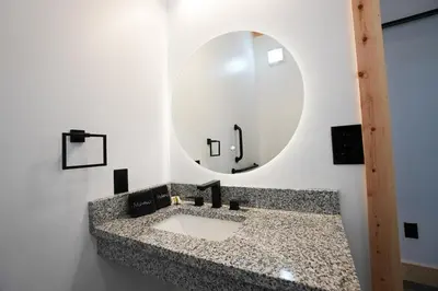 a bathroom with a sink and a mirror at Legends Lane E - by The Chalets in Logan