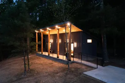 a small cabin with lights on the front at night at Legends Lane E - by The Chalets in Logan