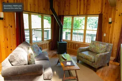 a living room with a couch and two chairs at Lilypad - by The Chalets in Logan