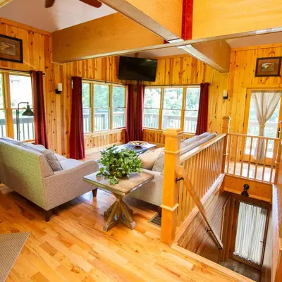 a living room with a couch and a table at Lilypad - by The Chalets in Logan