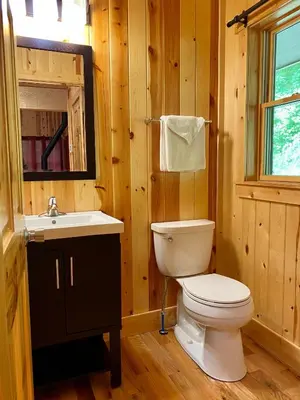 a bathroom with a white toilet and a sink at Lilypad - by The Chalets in Logan
