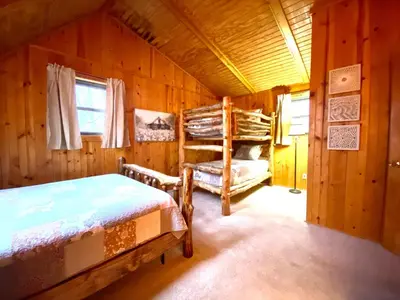 a bedroom with two bunk beds in a cabin at Oakridge - by The Chalets in South Bloomingville
