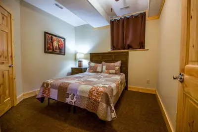 a bedroom with a bed and a window at Overlook - by The Chalets in Logan