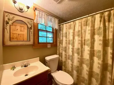 a bathroom with a toilet and a sink at Pioneer - by The Chalets in South Bloomingville