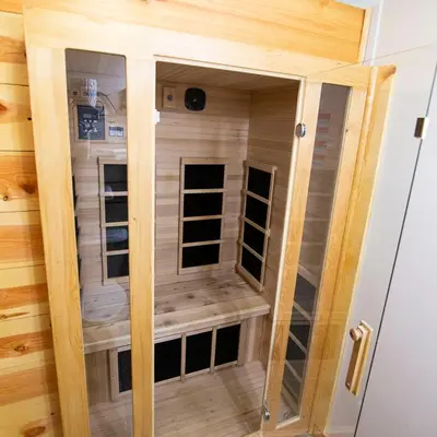 a sauna with a glass door in a cabin at Ravine - by The Chalets in Logan