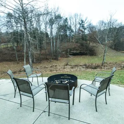 four chairs and a fire pit on a patio at Rockhouse - by The Chalets in Logan