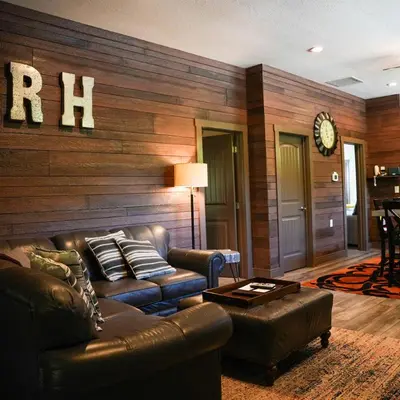 a living room with a leather couch and a table at Rockhouse - by The Chalets in Logan