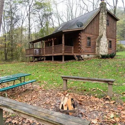 a log cabin with a deck and a picnic table at Sycamore - by The Chalets in South Bloomingville