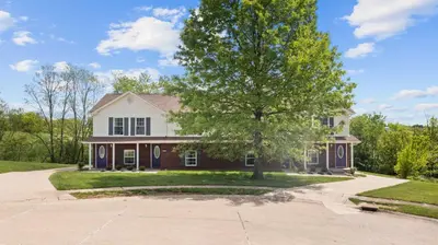 a house with a tree in the driveway at 2 BR 1 & half Bath Retreat, Sleeps 7, only 3 Miles to Ark! in Williamstown
