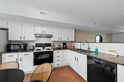 a kitchen with white cabinets and a table and chairs at 2 BR 1 & half Bath Retreat, Sleeps 7, only 3 Miles to Ark! in Williamstown