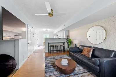 a living room with a leather couch and a table at 2 BR 1 & half Bath Retreat, Sleeps 7, only 3 Miles to Ark! in Williamstown