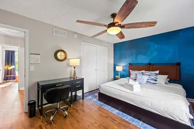 a bedroom with a bed and a desk with a ceiling fan at 3BR Condo Near Ark Encounter, 8 Guests, Parking in Williamstown