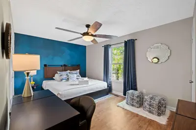 a bedroom with a bed and a ceiling fan at 3BR Condo Near Ark Encounter, 8 Guests, Parking in Williamstown
