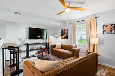 a living room with a couch and a tv at 3BR Condo Near Ark Encounter, 8 Guests, Parking in Williamstown