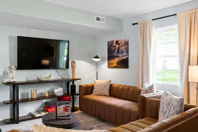 a living room with a couch and a tv at 3BR Condo Near Ark Encounter, 8 Guests, Parking in Williamstown