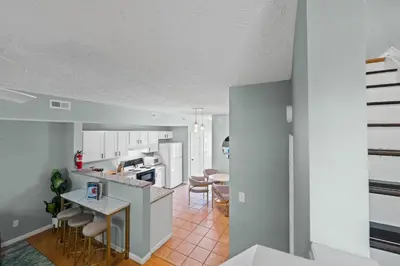 an open kitchen and living room with white cabinets at 3BR Condo for 7 - Only 3 Miles to Ark Encounter! in Williamstown