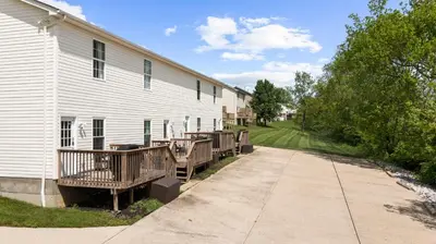 a building with wooden decks next to a building at 3BR Condo for 7 - Only 3 Miles to Ark Encounter! in Williamstown