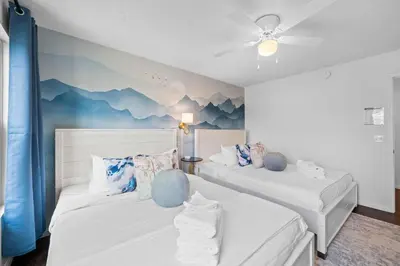 two beds in a room with mountains on the wall at 2BR Condo Near Ark for 6 Guests - Free Parking in Williamstown