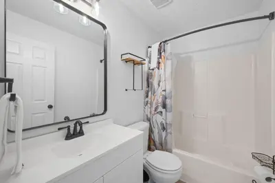 a bathroom with a sink and a toilet and a mirror at 2BR Condo Near Ark for 6 Guests - Free Parking in Williamstown