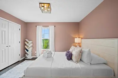 a bedroom with a large white bed with pillows at 2BR Condo Near Ark for 6 Guests - Free Parking in Williamstown